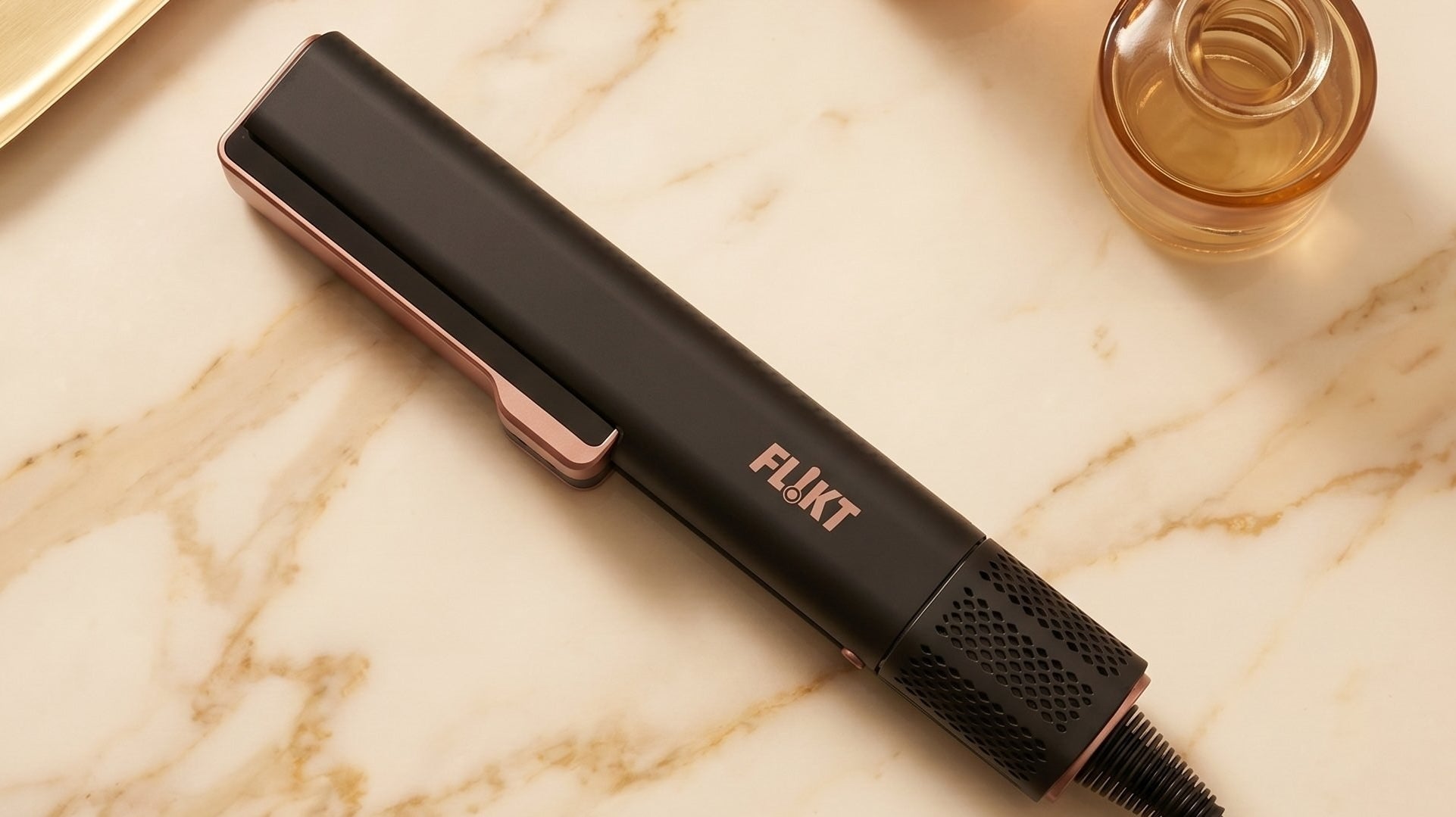 FL!KT wet-to-dry hair straightener gliding through damp hair with steam vents visible